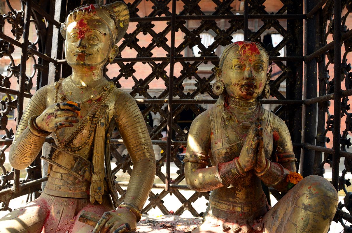 Kathmandu Changu Narayan 20 King Bhupatindra Malla And His Queen Kneel In a Gilded Cage Before The Main Entrance To Changu Narayan Temple King Bhupatindra Malla, the ruler of Bhaktapur from 1696 to 1722, and his queen kneel in a gilded cage in front of the main entrance to Changu Narayan Temple in the Kathmandu Valley.